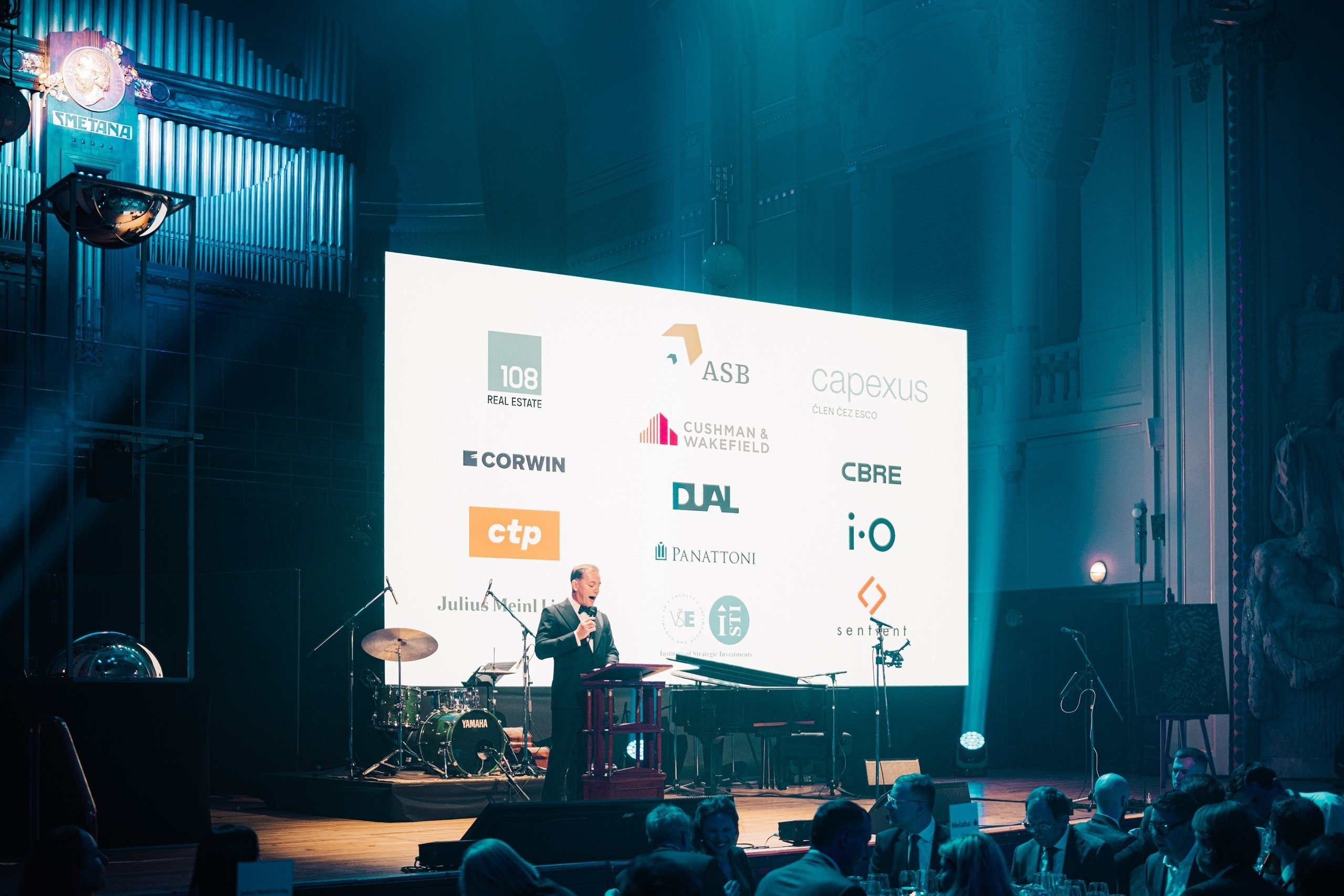 Event partner logos on stage screen at ThePrime Gala